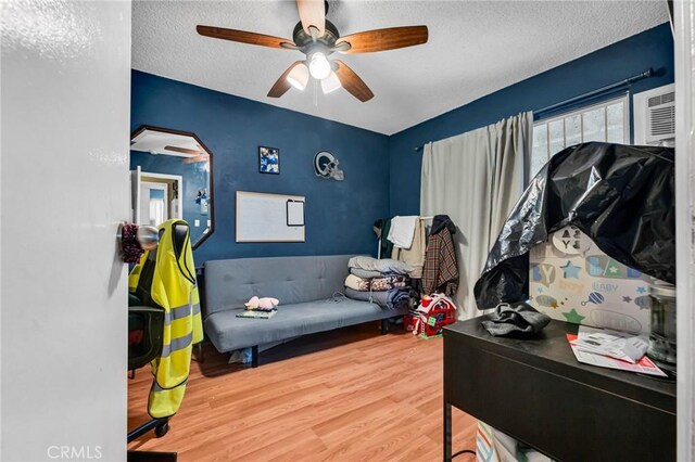 2660 Newell St, County Los Angeles, CA 90039 - bedroom with wood finished floors, a textured ceiling, ceiling fan, arched walkways, and an AC wall unit
