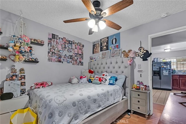 2660 Newell St, County Los Angeles, CA 90039 - bedroom featuring fridge with ice dispenser, light wood-type flooring, a textured ceiling, and ceiling fan