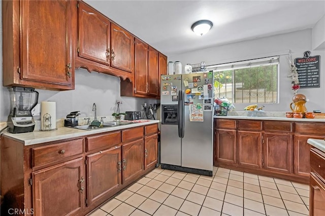 2660 Newell St, County Los Angeles, CA 90039 - kitchen featuring stainless steel fridge, light countertops, light tile patterned floors, and brown cabinets