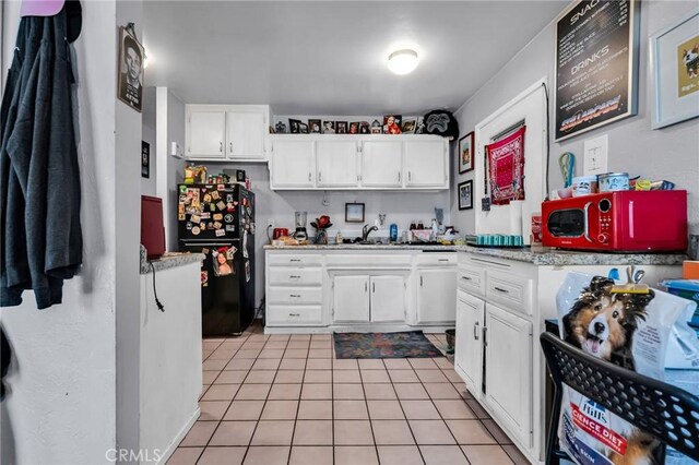 2660 Newell St, County Los Angeles, CA 90039 - kitchen featuring freestanding refrigerator, light tile patterned flooring, and white cabinets