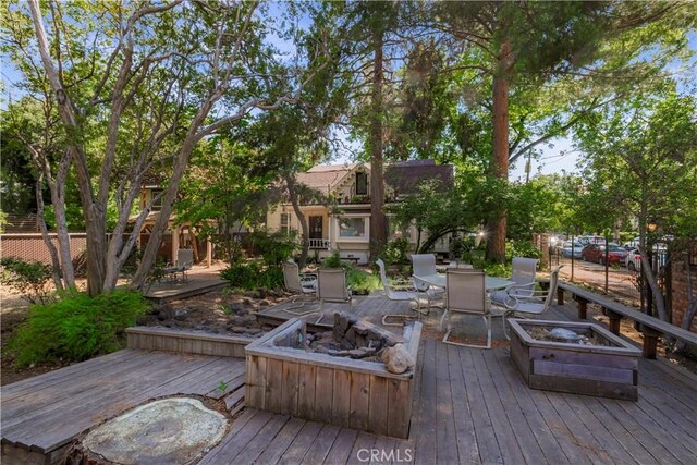 604 Salem St, Chico, CA 95928 - wooden deck with an outdoor fire pit and outdoor dining space