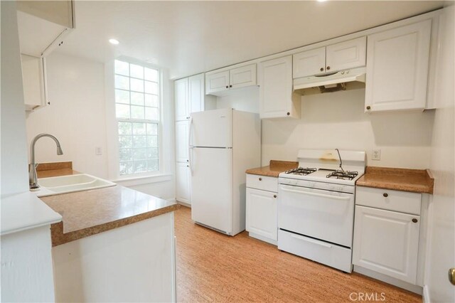 604 Salem St, Chico, CA 95928 - kitchen with white appliances, under cabinet range hood, white cabinetry, and recessed lighting