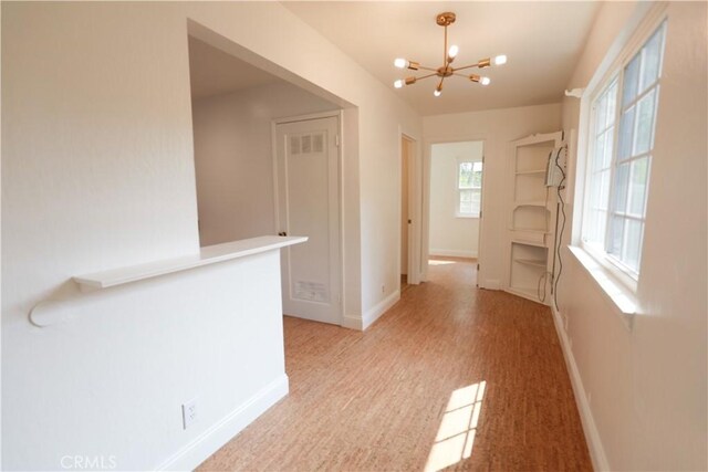 604 Salem St, Chico, CA 95928 - hallway featuring a chandelier and light colored carpet