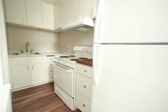 604 Salem St, Chico, CA 95928 - kitchen with white appliances, under cabinet range hood, dark wood-type flooring, light countertops, and white cabinets