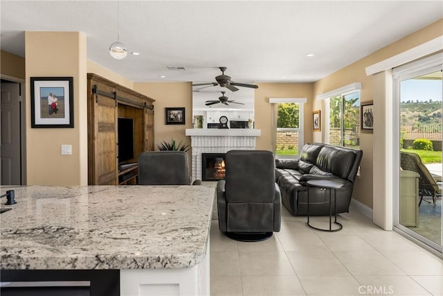 24330 Via Arriba Linda, Yorba Linda, CA 92887 - living room featuring a barn door, a ceiling fan, a brick fireplace, light tile patterned flooring, and recessed lighting