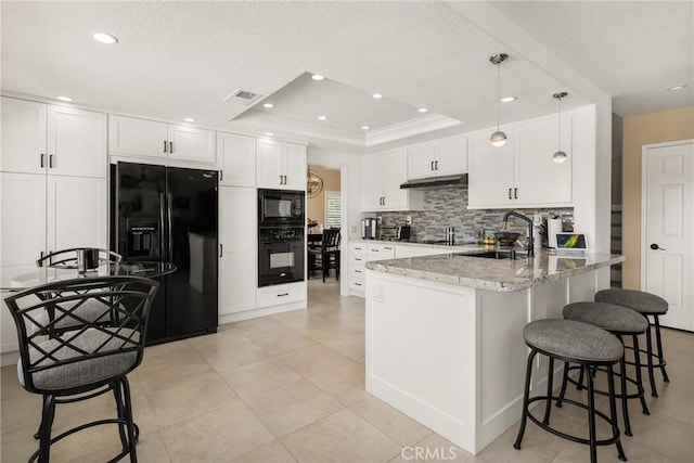 24330 Via Arriba Linda, Yorba Linda, CA 92887 - kitchen with black appliances, under cabinet range hood, a peninsula, white cabinets, and a breakfast bar area
