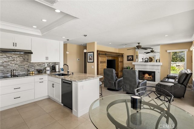 24330 Via Arriba Linda, Yorba Linda, CA 92887 - kitchen featuring black appliances, under cabinet range hood, a peninsula, backsplash, and a fireplace