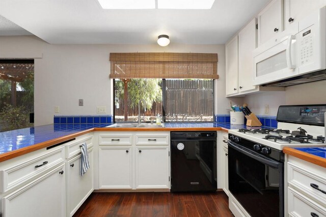 468 Las Brisas Dr, Escondido, CA 92027 - kitchen featuring black dishwasher, gas stove, white microwave, white cabinetry, and dark wood-style flooring