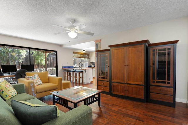468 Las Brisas Dr, Escondido, CA 92027 - living area with dark wood-style flooring, ceiling fan, and a textured ceiling