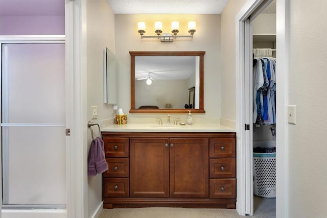468 Las Brisas Dr, Escondido, CA 92027 - full bathroom featuring a shower stall, vanity, a spacious closet, and a ceiling fan