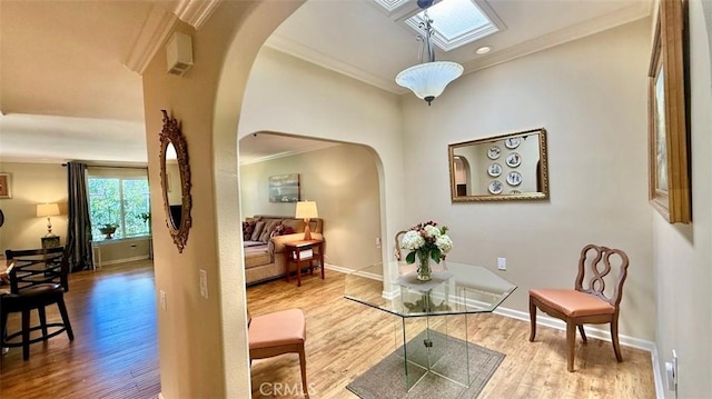 3001 Via Buena Vis Unit C, Laguna Woods, CA 92637 - sitting room featuring arched walkways, a skylight, wood finished floors, and ornamental molding