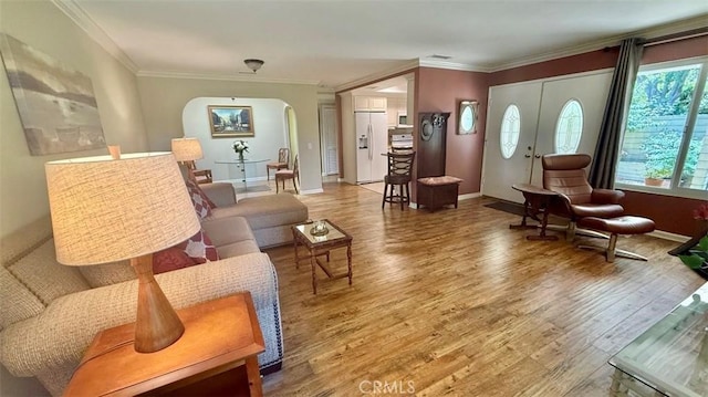 3001 Via Buena Vis Unit C, Laguna Woods, CA 92637 - living room featuring arched walkways, wood finished floors, and crown molding