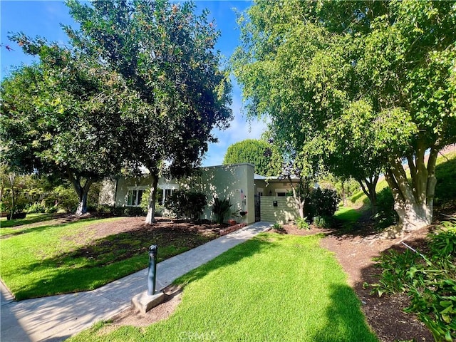 3001 Via Buena Vis Unit C, Laguna Woods, CA 92637 - view of front facade with a front yard and stucco siding