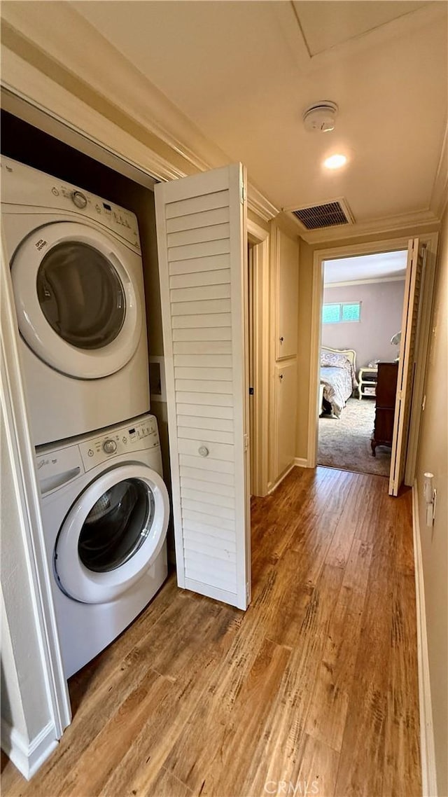 3001 Via Buena Vis Unit C, Laguna Woods, CA 92637 - laundry area featuring estacked washer and dryer and light wood-style flooring