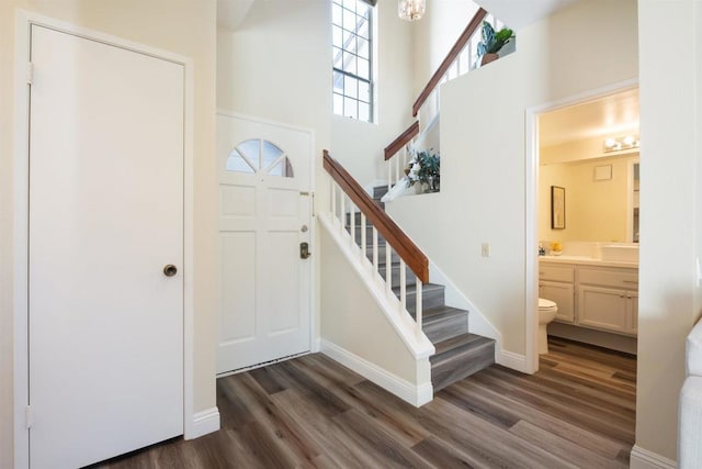 13667 Tiverton Rd, San Diego, CA 92130 - foyer with stairs, dark wood-type flooring, a high ceiling, and a chandelier