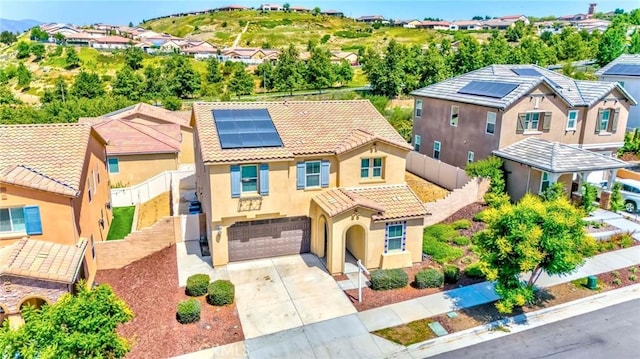 24679 Acadia Dr, Corona, CA 92883 - view of front of property with a tile roof, concrete driveway, roof mounted solar panels, stucco siding, and an attached garage