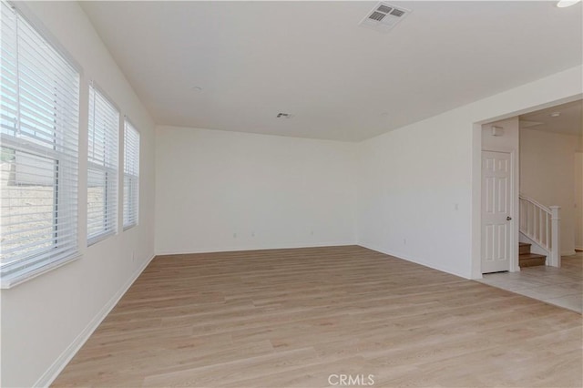 24679 Acadia Dr, Corona, CA 92883 - spare room with light wood finished floors and stairway