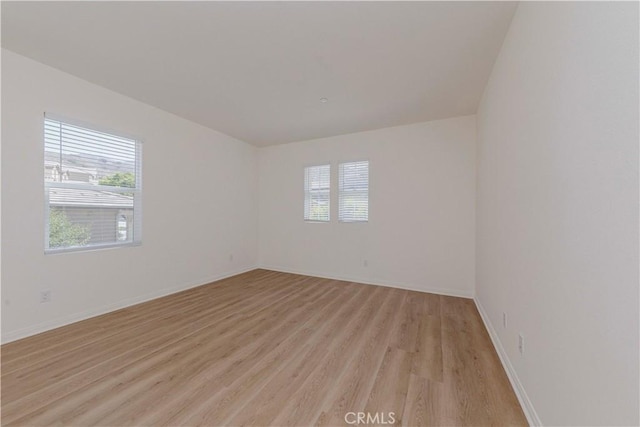 24679 Acadia Dr, Corona, CA 92883 - empty room featuring plenty of natural light and light wood-style flooring
