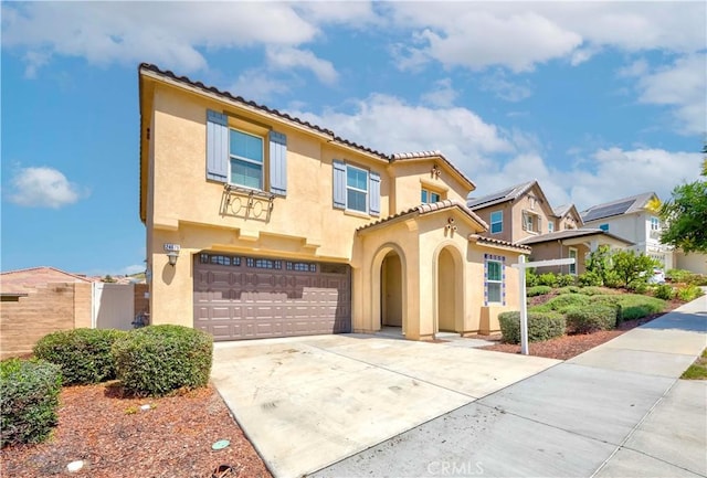 24679 Acadia Dr, Corona, CA 92883 - mediterranean / spanish-style home with stucco siding, an attached garage, a tile roof, and driveway