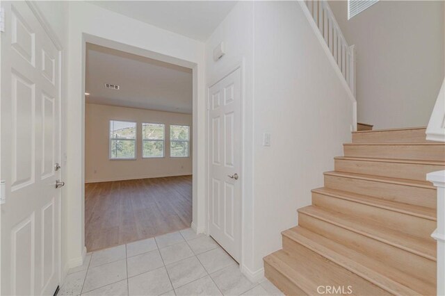 24679 Acadia Dr, Corona, CA 92883 - stairs featuring tile patterned flooring and baseboards