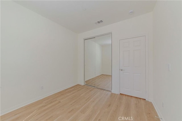 24679 Acadia Dr, Corona, CA 92883 - unfurnished bedroom featuring light wood-style floors and a closet