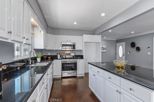 5337 Canehill Ave, Lakewood, CA 90713 - kitchen featuring appliances with stainless steel finishes, white cabinets, dark wood-style flooring, recessed lighting, and crown molding