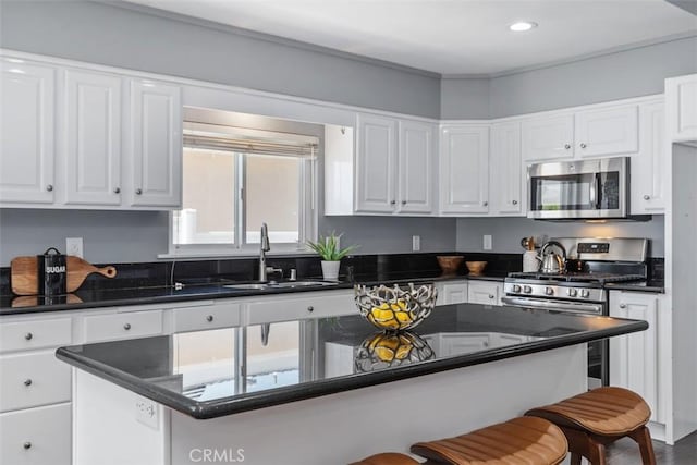 5337 Canehill Ave, Lakewood, CA 90713 - kitchen featuring stainless steel appliances, a kitchen breakfast bar, white cabinetry, recessed lighting, and a center island