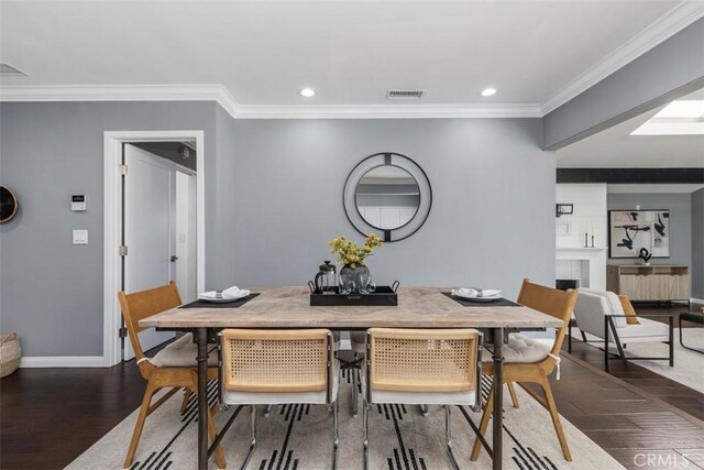 5337 Canehill Ave, Lakewood, CA 90713 - dining space featuring wood finished floors, crown molding, recessed lighting, and a fireplace