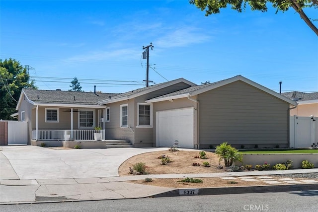 5337 Canehill Ave, Lakewood, CA 90713 - ranch-style house featuring a porch, concrete driveway, and a garage