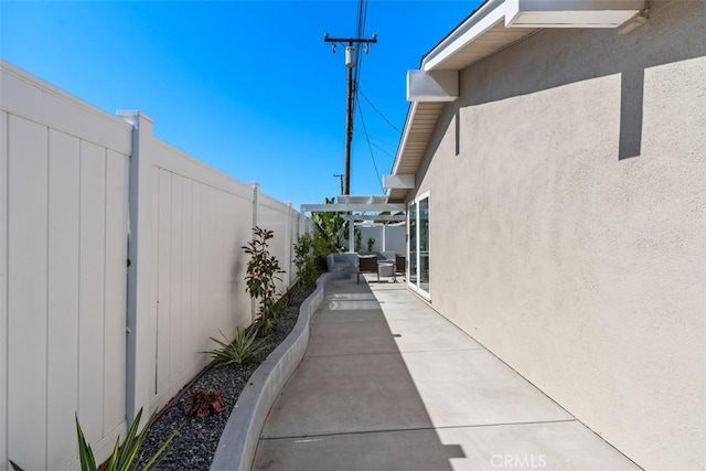 5337 Canehill Ave, Lakewood, CA 90713 - view of side of property with a patio, a fenced backyard, stucco siding, and a pergola