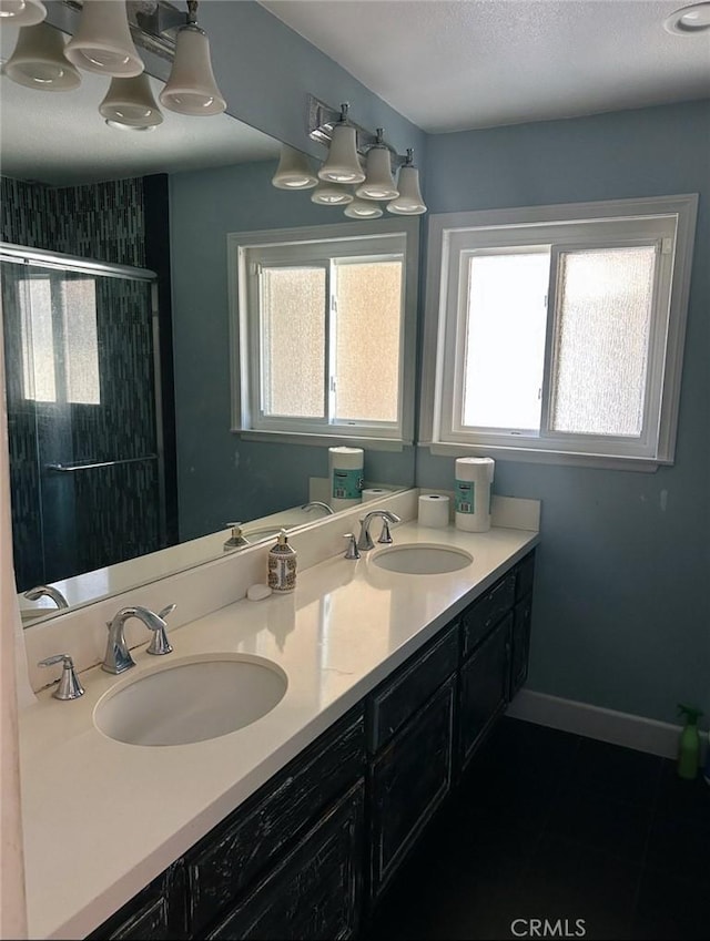 23774 Burton St, West Hills, CA 91304 - bathroom featuring healthy amount of natural light, a shower stall, double vanity, and a textured ceiling