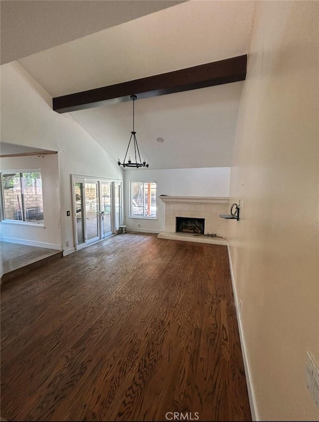 23774 Burton St, West Hills, CA 91304 - unfurnished living room with wood finished floors, beam ceiling, a fireplace with raised hearth, healthy amount of natural light, and a chandelier