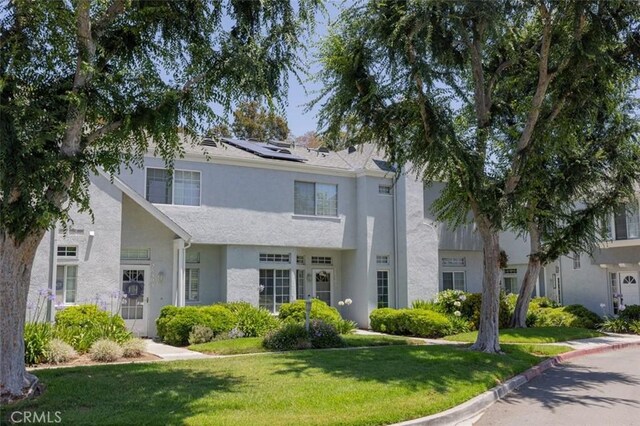 28305 Paseo El Siena Unit 10, Laguna Niguel, CA 92677 - view of front of home featuring a front yard, stucco siding, and solar panels