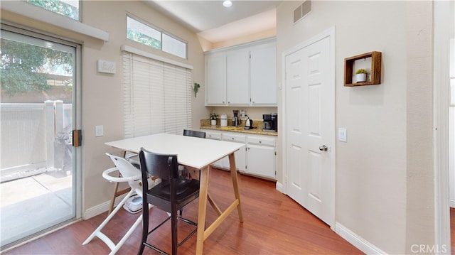 28305 Paseo El Siena Unit 10, Laguna Niguel, CA 92677 - kitchen with light countertops, white cabinetry, and light wood-style floors