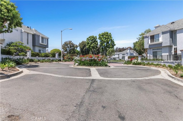 28305 Paseo El Siena Unit 10, Laguna Niguel, CA 92677 - view of asphalt road with a residential view, street lights, and curbs