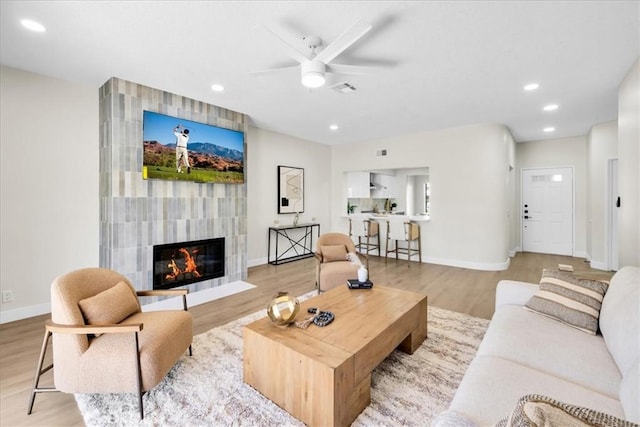 191 Desert Falls Cir, Palm Desert, CA 92211 - living area with a ceiling fan, a tiled fireplace, wood finished floors, and recessed lighting