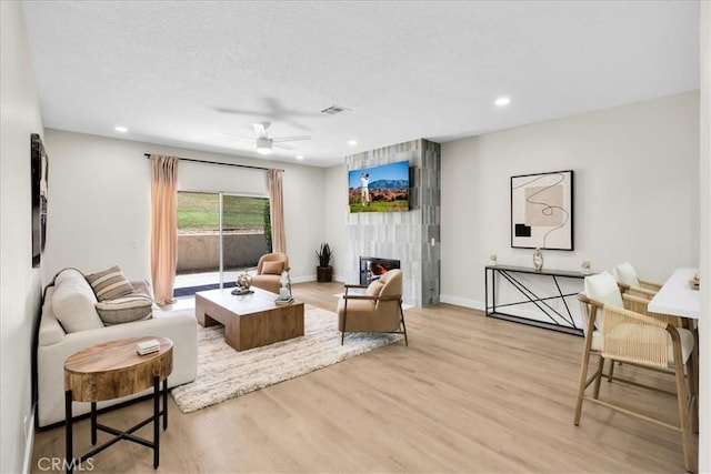 191 Desert Falls Cir, Palm Desert, CA 92211 - living area with ceiling fan, wood finished floors, a tile fireplace, and recessed lighting