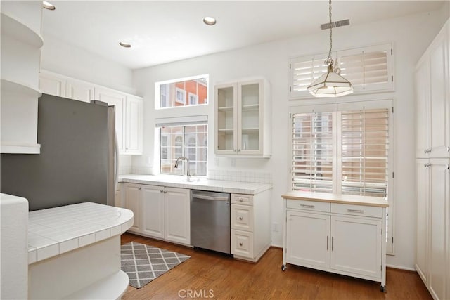6 Garzoni Aisle, Irvine, CA 92606 - kitchen with appliances with stainless steel finishes, white cabinetry, glass insert cabinets, tile countertops, and recessed lighting