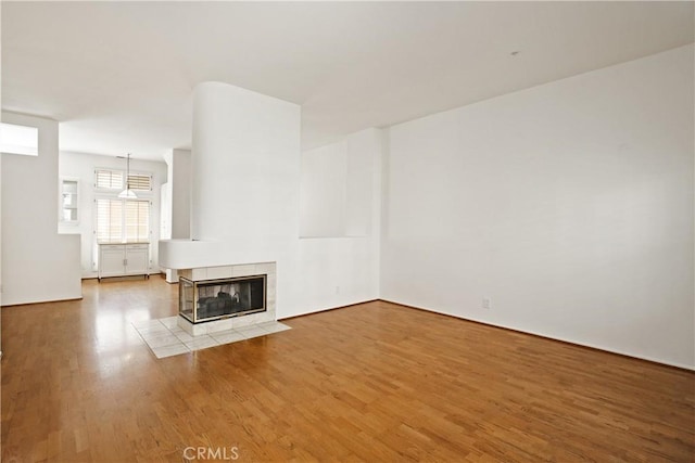 6 Garzoni Aisle, Irvine, CA 92606 - unfurnished living room featuring wood finished floors and a fireplace
