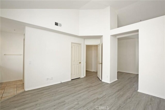 6 Garzoni Aisle, Irvine, CA 92606 - unfurnished bedroom with high vaulted ceiling, wood finished floors, and a closet
