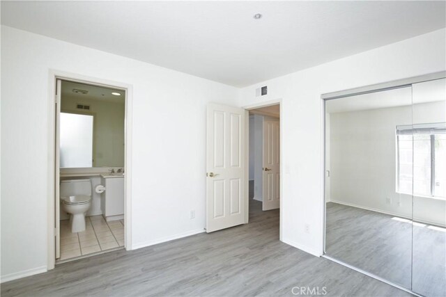 6 Garzoni Aisle, Irvine, CA 92606 - unfurnished bedroom with wood finished floors, a closet, and connected bathroom