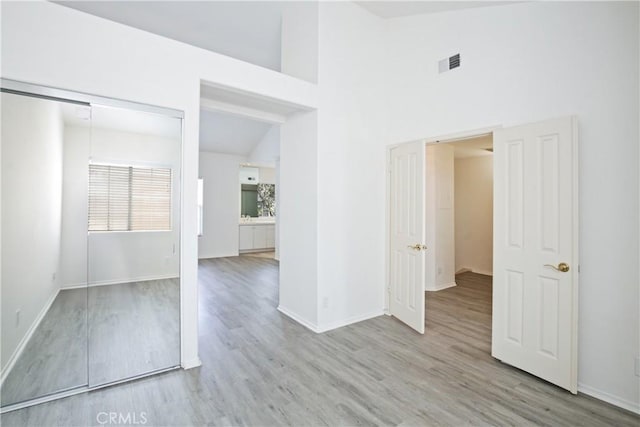 6 Garzoni Aisle, Irvine, CA 92606 - unfurnished room featuring wood finished floors and a towering ceiling