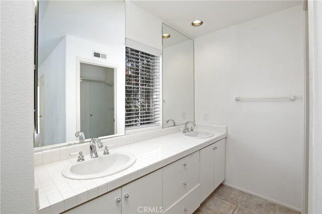 6 Garzoni Aisle, Irvine, CA 92606 - bathroom featuring double vanity and tile patterned floors