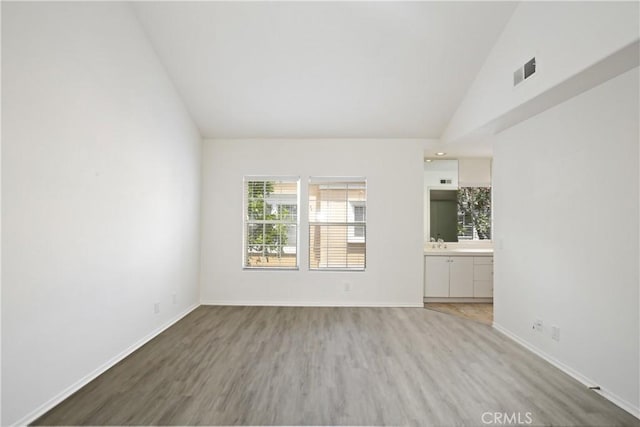 6 Garzoni Aisle, Irvine, CA 92606 - unfurnished room featuring light wood-style flooring and high vaulted ceiling