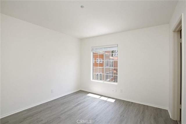 6 Garzoni Aisle, Irvine, CA 92606 - unfurnished bedroom featuring wood finished floors and baseboards