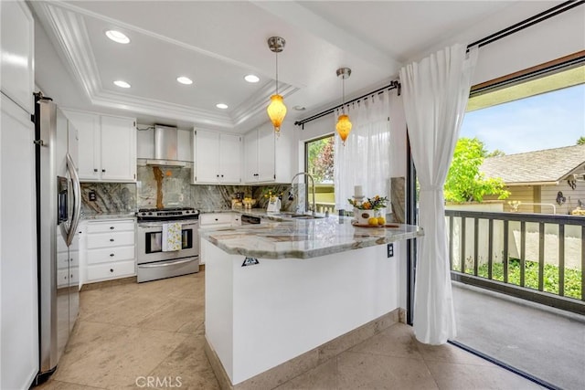 20 Nuevo Unit 10, Irvine, CA 92612 - kitchen featuring appliances with stainless steel finishes, wall chimney exhaust hood, a peninsula, a tray ceiling, and decorative backsplash