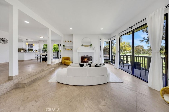 20 Nuevo Unit 10, Irvine, CA 92612 - living area featuring a warm lit fireplace, built in features, and recessed lighting