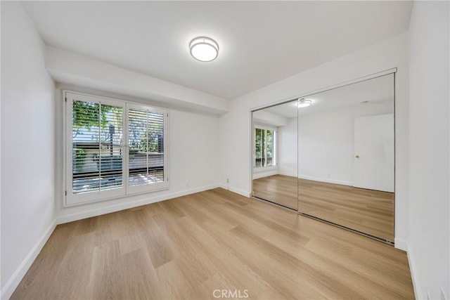 20 Nuevo Unit 10, Irvine, CA 92612 - unfurnished bedroom featuring wood finished floors and a closet