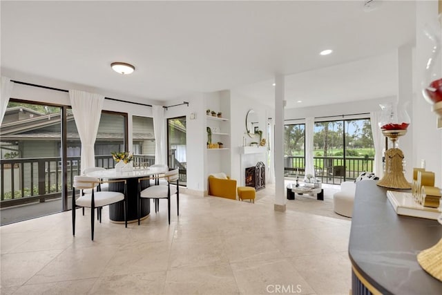 20 Nuevo Unit 10, Irvine, CA 92612 - dining area with a lit fireplace, recessed lighting, and built in features