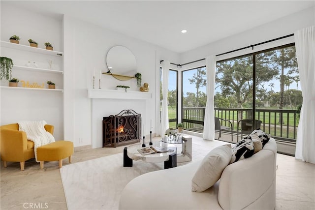 20 Nuevo Unit 10, Irvine, CA 92612 - living room with a lit fireplace, recessed lighting, and built in shelves